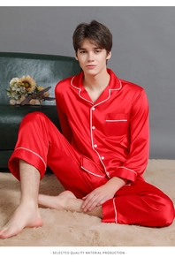 Close-up of men's red silk satin pajama set with contrast white piping details