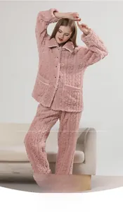 Detailed view of pink coral fleece pajamas with cable knit texture and button-up lapel