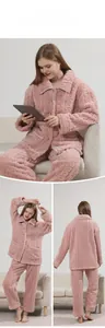 Detail of pink coral fleece pajama set showing cable knit texture and button-up design