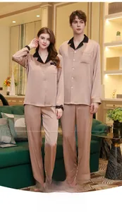 Detail of champagne silk pajamas with black contrast lapels and lace cuffs for couples