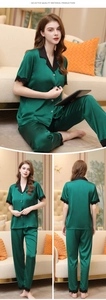 Detail of dark green silk pajamas with black lace trim and button-down collar design