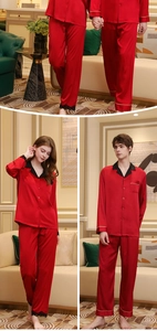 Detail of red silk couple pajamas featuring delicate black lace trim on women's pants