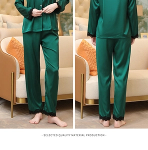 Detailed view of dark green satin pajama set with black lace trim on sleeves and hem