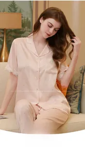 Pink silk pajamas detail featuring delicate white lace trim and subtle silver glitters