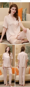 Detail of pink silk pajama set showing lace hem cuffs and delicate polka dot pattern