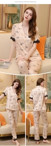 Detail of pink silk pajama set featuring floral print and delicate black eyelash lace trim