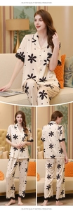 Detail of silk pajama cuffs and hem featuring black eyelash lace trim and floral print
