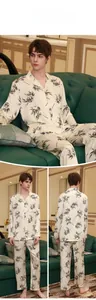 Detail of men's silk pajama set with black bamboo leaf print on cream fabric