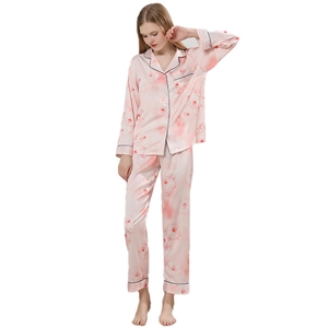 Pink floral silk pajamas set with long sleeve button-up top and matching pants