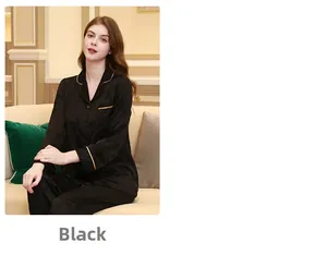 Detail of black silk pajamas with gold piping and floral jacquard patterns