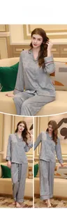 Close-up of gray silk pajamas with maple leaf patterns and red contrast piping detail