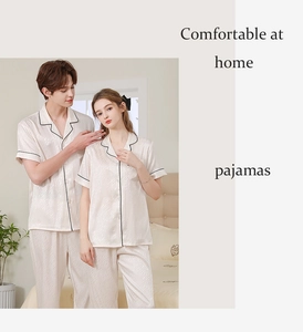 Detail of silk-like pajama set with contrast black piping and wavy textured fabric