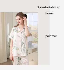 Close-up of ivory floral silk satin pajamas featuring short sleeves and notched collar