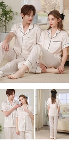 Close-up of silk pajama set showing ripple texture fabric and black piping details