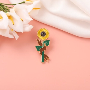 Cute Japanese style sunflower enamel brooch with green leaves and ribbon on pink backdrop