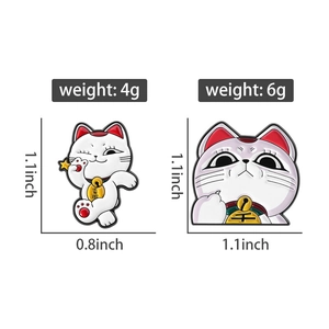 Detail view of lucky cat enamel pins with height dimensions and weight specifications