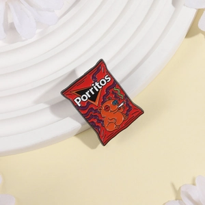 Close-up of red snack bag enamel pin with capybara pattern on a white display stand