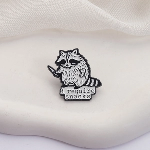 Cute cartoon raccoon enamel pin with a knife and i require snacks slogan badge
