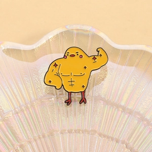 Creative muscular yellow chicken enamel pin brooch on a pearlescent tray accessory