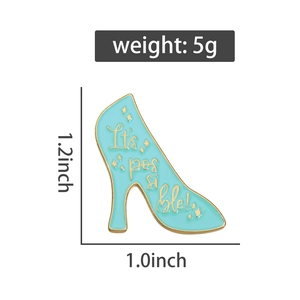 Detailed view of enamel high heel brooch in light blue with gold lettering and dimensions
