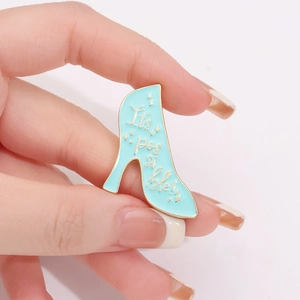Light blue enamel stiletto pin with It's possible text and gold metal accents