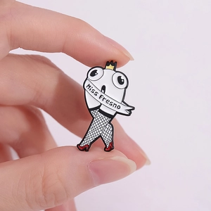 Quirky Miss Fresno enamel pin with white creature, crown, and fishnet stockings on pink background