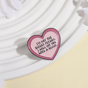 Pink heart enamel pin featuring humorous quote on white decorative background