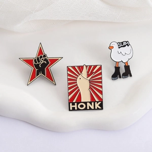Funny enamel duck pins set with HONK and SLAY text on white decorative stand