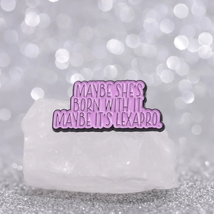 Pink enamel brooch with black trim featuring creative quotes on white crystal stand