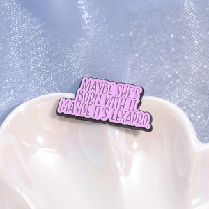 Purple enamel badge with humor quote on shell plate over blue textured background