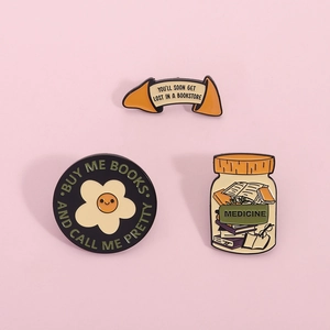Enamel book brooch set featuring bookstore and medicine bottle designs for readers