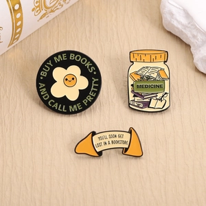 Three-piece set of enamel pins for book lovers featuring cute library and reading quotes