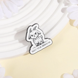 Angry cartoon goat enamel pin in black and white with GOAT TO BE KIDDING ME pun