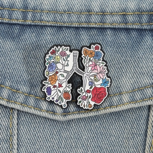 Creative lung shape enamel pin with colorful floral patterns on denim fabric