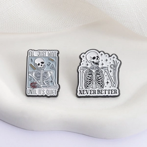 Funny skeleton enamel pins featuring OK hand gesture and classroom humor on white background
