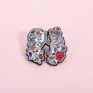 Artistic anatomical lung pin brooch with colorful floral patterns and black metal outlines