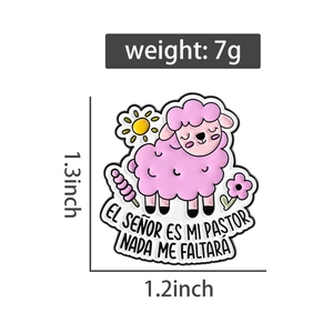 Detailed view of pink sheep enamel brooch with flower and sun motifs on white background