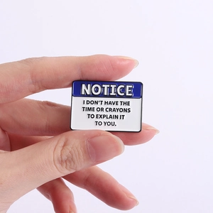 Funny blue Notice enamel pin with sarcastic quote held by hand on a purple backdrop