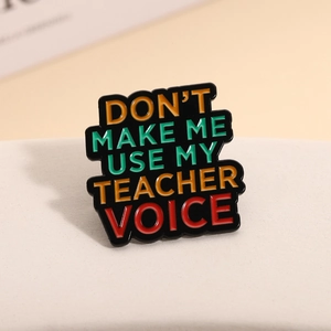 Enamel pin with humorous 'Don't Make Me Use My Teacher Voice' quote for backpacks