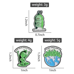 Detailed view of three enamel pea pod badges with creative world peace theme engravings