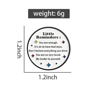 Detail shot of the 1.2-inch round enamel pin showing weight and self-care quote