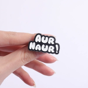 Funny AUR NAUR slang enamel pin in black and white finish for creative outfit decoration