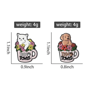 Detail view of cat and dog paw enamel pins with dimensions 1.1 inch and paw power text