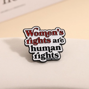 Women's rights are human rights enamel pin badge accessory with white background and red text