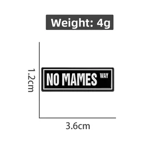 Detail view of a 3.6cm rectangle enamel pin with NO MAMES WAY text and weight measurement