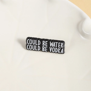 Black enamel pin badge with 'COULD BE WATER COULD BE VODKA' funny slogan for clothing