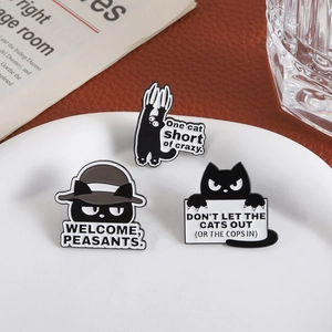 Funny black cat enamel pins set featuring humorous text on white ceramic tray