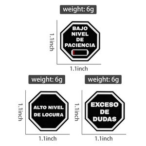 Set of three black enamel badges with Spanish humorous text measuring 1.1x1.1 inches