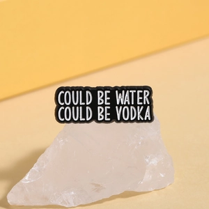 Funny enamel brooch featuring COULD BE WATER COULD BE VODKA text on polished black base