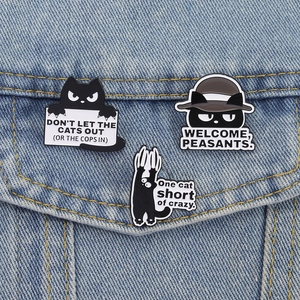 Three cute black cat enamel pins set on denim jacket with funny humor quotes